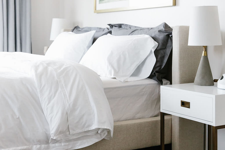 minimalist bedroom with white bed frame