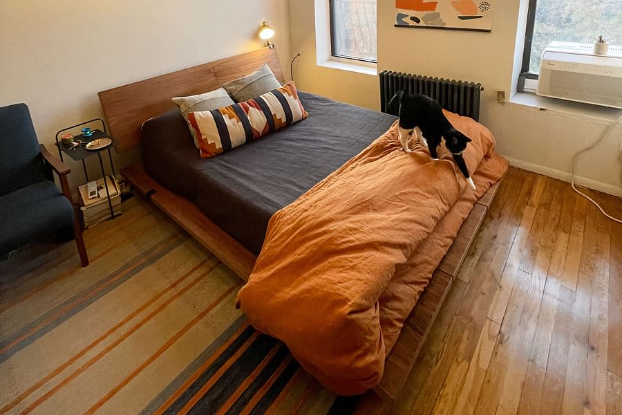 A happy user assembling the Floyd Bed Frame