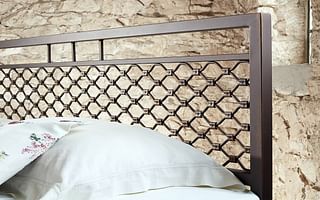 How can I attach a metal headboard to a bed frame without holes?