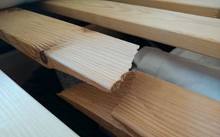 How to fix a weakened center support slat on a bed frame?